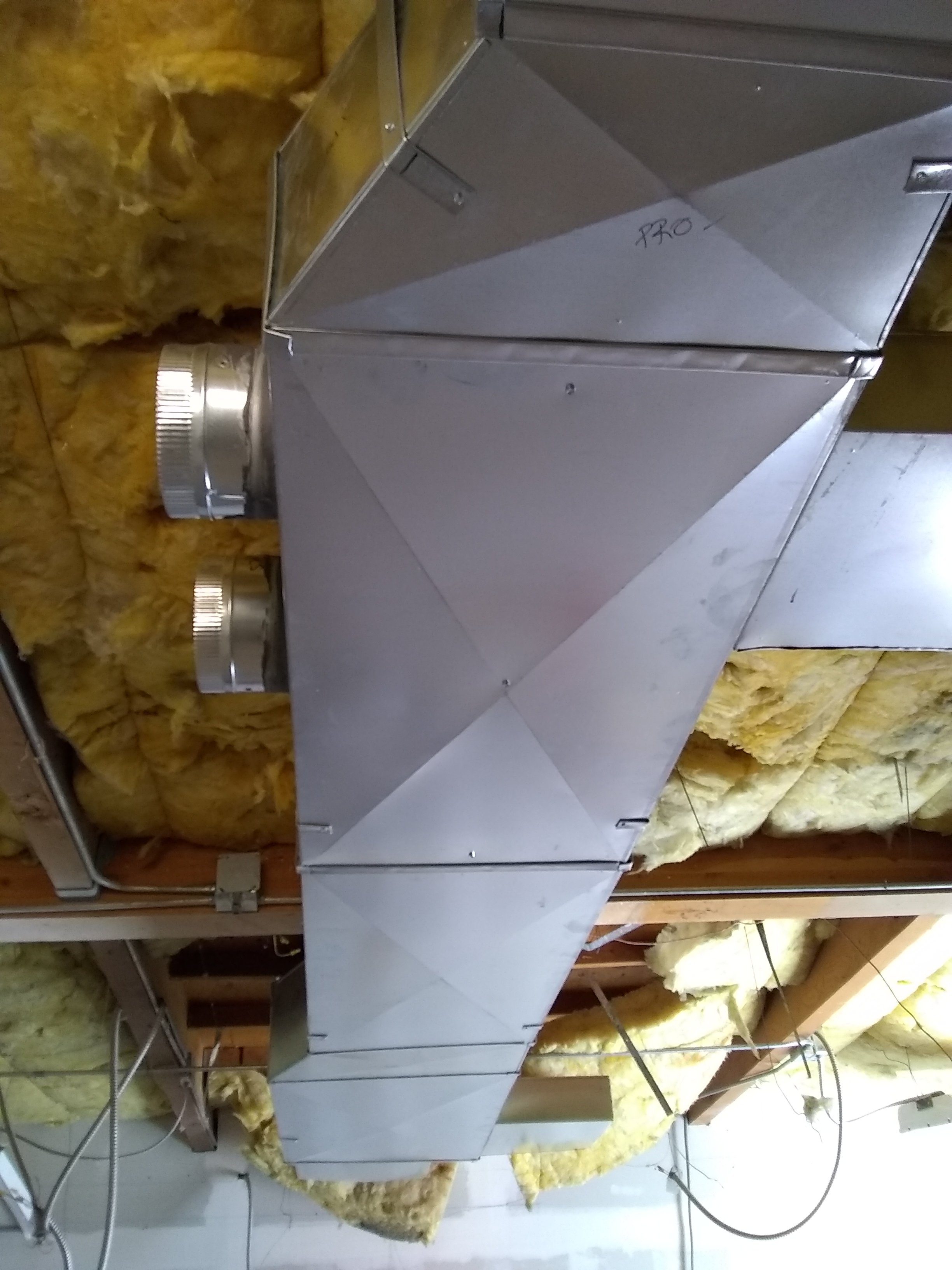 A custom sheet metal plenum being installed in a Scottsdale tenant improvement project