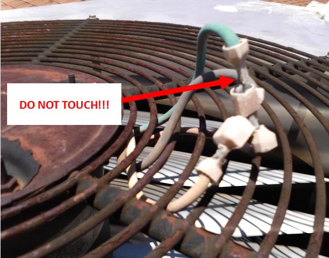 dangerous fan motor wires with exposed high voltage metal connectors waiting to shock someone